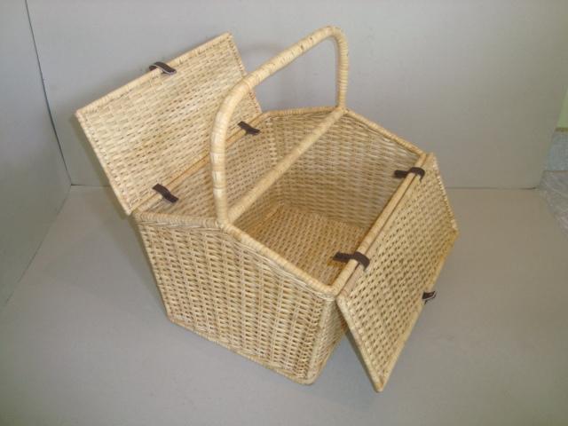 House keeping basket made of cane with two lids and a handle